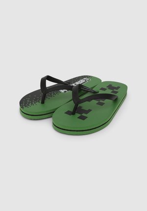 Infradito verdi con cinturini in gomma nera, caratterizzati da un design a motivo con accenti pixelati e la scritta "Minecraft" sulla soletta.