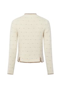 Gebreide trui met een crèmekleurige basis, voorzien van kleine beige stippen. Ronde halslijn, lange mouwen en een contrasterende beige zoom aan de onderkant.