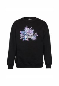 Sort sweatshirt med lange ærmer, der har et farverigt grafisk design af blomster og teksten "JUST RHYSE" i hvidt på forsiden.
