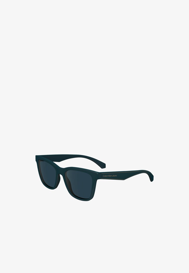 Lunettes de soleil rectangulaires noires Calvin Klein Jeans avec verres foncés et montures épaisses.