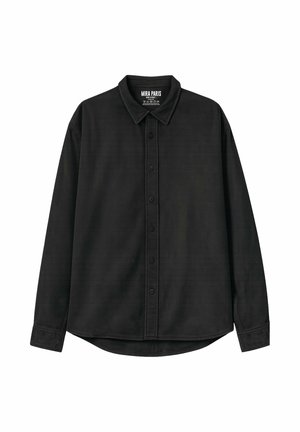 Chemise noire à manches longues avec col, boutons sur le devant et coutures visibles, étiquette de marque "MIRA PARIS" à l'intérieur du col.