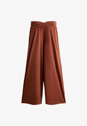 Brede broek in rustoranje stof, met een geassembleerde elastische tailleband en een vloeiende drape die de beweging versterkt.