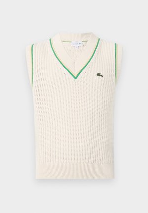 V-neck sleeveless knit sweater in cream with green accents along the neckline and armholes. Features a breathable texture and logo detail.