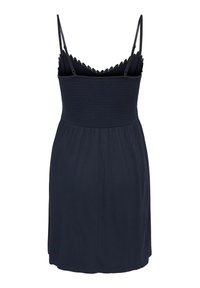 Robe noire sans manches avec bretelles spaghetti réglables, corsage élastique smocké, bordure en dentelle au niveau de l'encolure et jupe longueur genou.