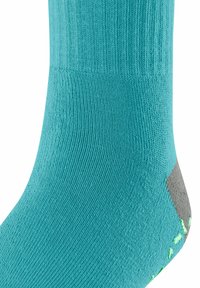 Türkiser Socken aus strukturiertem Stoff mit einem gerippten Design, das graue Akzente an Spitze und Ferse sowie reflektierende grüne Details aufweist.