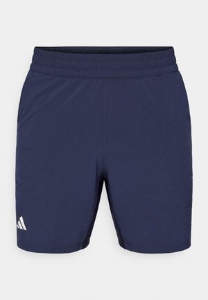 Marineblaue Sportshorts mit elastischem Bund, strukturierter Stoffoberfläche und weißen Logoakzenten am Saum. Standardpassform, knielanges Design.