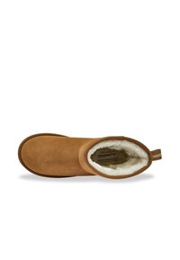 Stivale alla caviglia in suede marrone con morbida fodera in pelliccia bianca. Punta tonda, tacco basso e linguetta posteriore per un facile indosso.