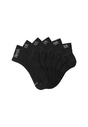 Black ankle socks in a pack of six, made from a smooth fabric. Each sock features a ribbed cuff and the printed brand name "Bench."