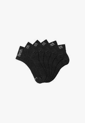 Black ankle socks in a pack of six, made from a smooth fabric. Each sock features a ribbed cuff and the printed brand name "Bench."