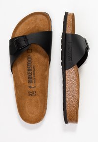 Sorte Birkenstock slidesandaler med kork sål, struktureret læderoverdel, justerbar rem og gummiydersål, størrelse 37.