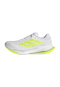 White running shoe with neon yellow accents, three side stripes, a textured upper, and a cushioned sole featuring a distinct curve.