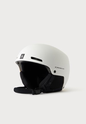 Casque de sport Oakley blanc avec rembourrage intérieur noir et sangle de menton, taille XL, conçu pour la protection de la tête.