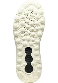 Suela blanca de zapato con goma texturizada y patrones circulares; una sección central negra añade contraste y agarre.