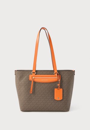 Bruine boodschappentas met oranje leren handvatten, voorzak met ritssluiting en een merklabel dat aan een van de handvatten hangt.