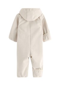 Beige fleece heldragt med hætte, lange ærmer og ombukket mansjetter. Blød tekstur, sømløst design og uden synlige lukninger.