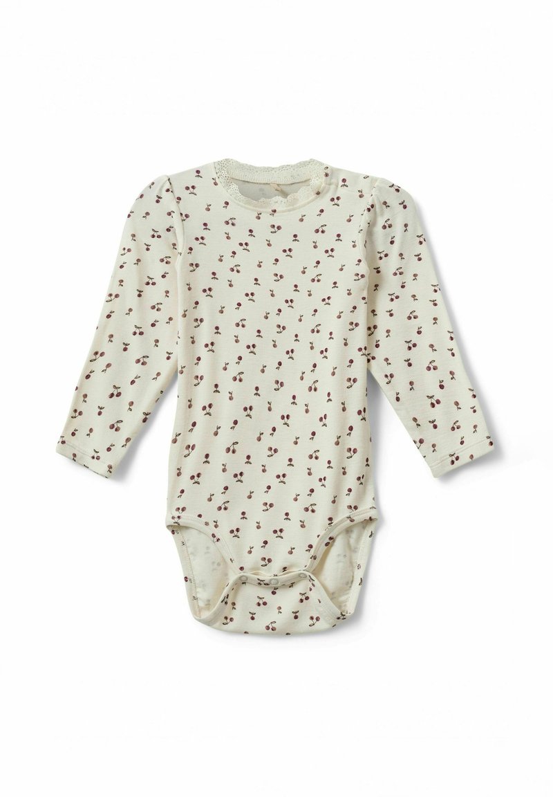 Kerman hihaton vauvan bodysuit, jossa on kermaisen värinen kangas, punainen kukkapaino, pyöreä kaula-aukko ja neppari alhaalla.