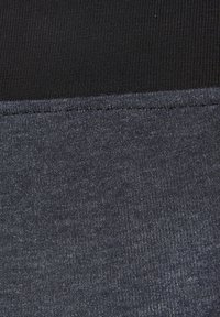 Cotton-blend leggings featuring a black ribbed waistband and a soft, textured dark gray lower section with subtle heathering.