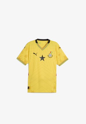 Sárga sportmez rövid ujjakkal, fekete V-nyakkal, csillag mintázattal, hímezett logóval és finom textúrájú díszítő mintákkal.