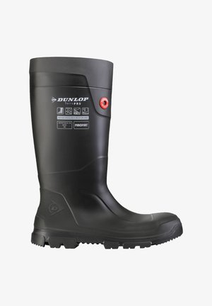 Black Dunlop Terra PRO waterproof safety boot with reinforced sole and ankle, labeled with safety and temperature ratings.