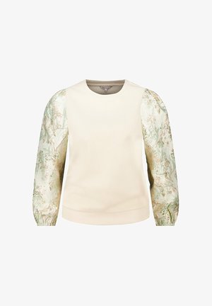 Crèmekleurige top met lange mouwen, een effen lichaam en glanzende, gestructureerde, opgeblazen mouwen met een groen- en goudkleurig bloemmotief.