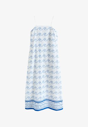 White sleeveless dress with thin straps, blue wave patterns throughout, and names of Greek islands along the hem.