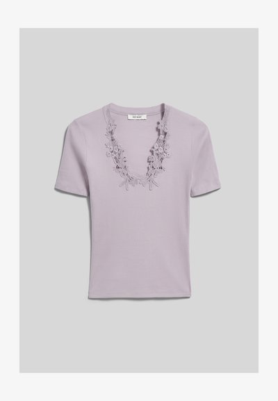 Haut en maille côtelée lilas à manches courtes avec un décolleté en V profond orné d’une bordure en dentelle florale, présenté à plat sur un fond gris.