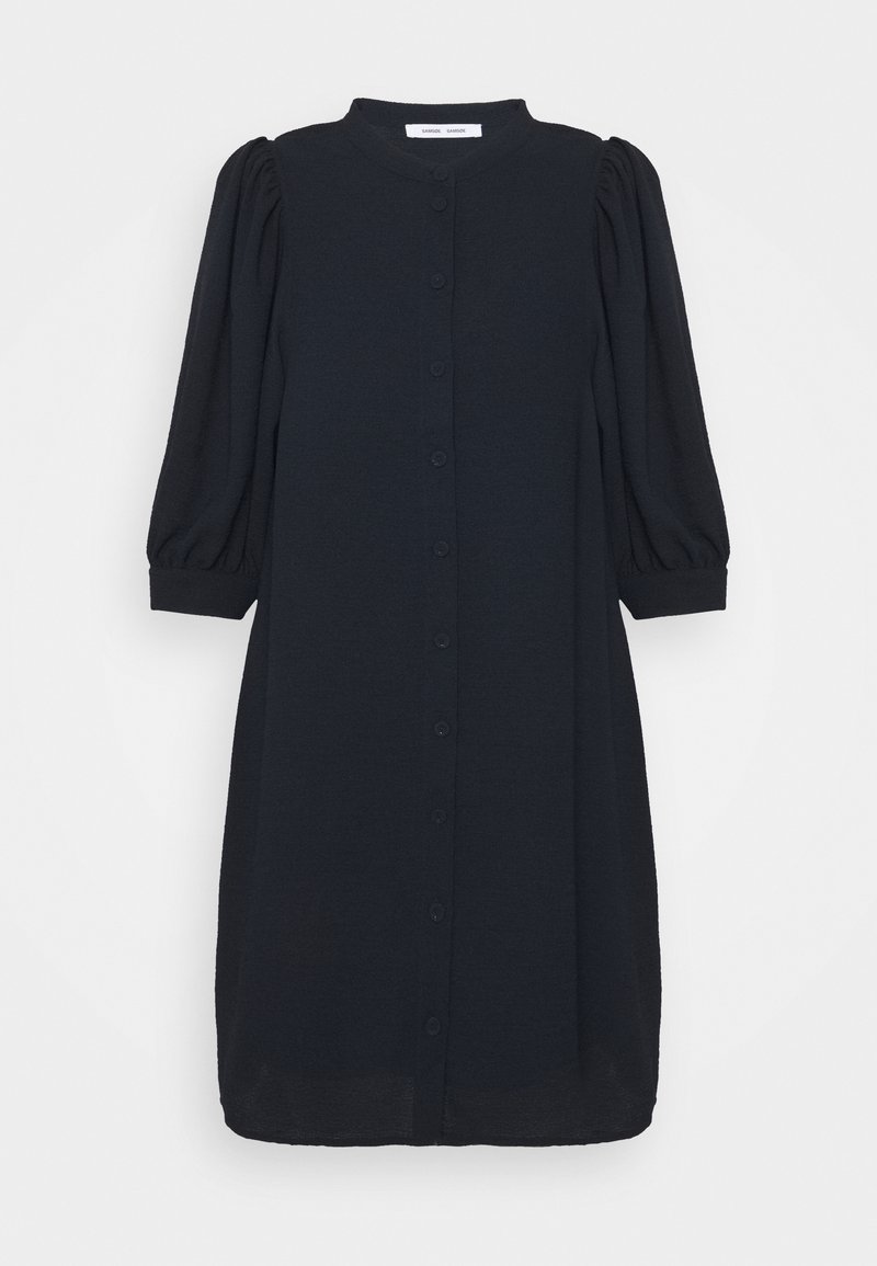 Robe noire mi-longue à encolure ronde, manches longues bouffantes, fermeture boutonnée devant et poignets ajustés.