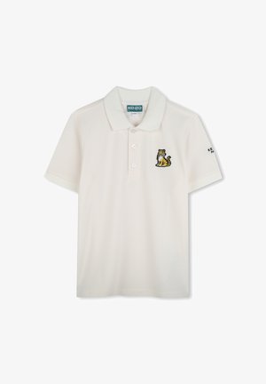 Polo shirt in lichtbeige katoen met een kraag, drie knopen en een geborduurd tijgerlogo op de linkerborst. Korte mouwen.