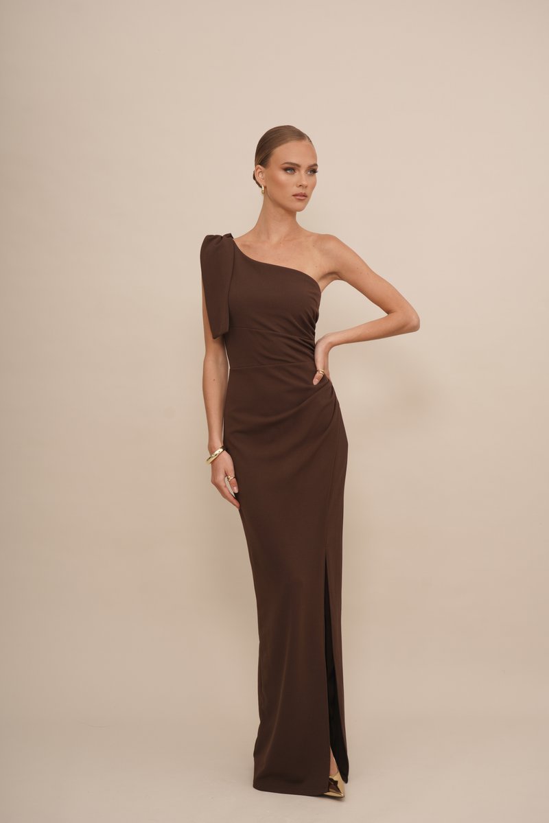 Braunes One-Shoulder-Kleid mit figurbetontem Schnitt, seitlichem Schlitz und dekorativem Bogen an der Schulter; glattes, mattes Material.