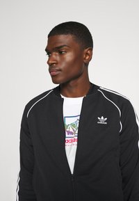 adidas Originals Cipzáras pulóver - black/white