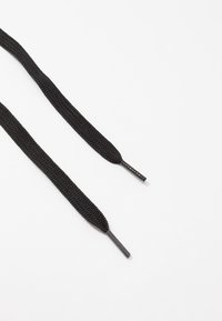 Černé tkaničky s plochým, texturovaným povrchem a plastovými konci. Každá tkanička je přibližně 100 cm dlouhá, vhodná pro různé druhy obuvi.