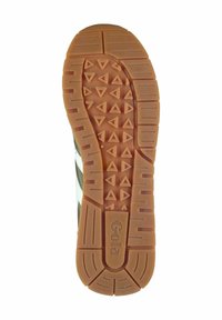 Semelle en caoutchouc avec une surface texturée et à motifs. Présente des crampons triangulaires et rectangulaires pour une meilleure adhérence. La couleur est beige avec une teinte brunâtre.