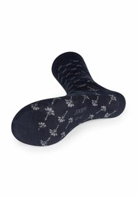 Calzini blu navy con una consistenza morbida, caratterizzati da un motivo floreale bianco. Include il logo sulla suola. Polsino rinforzato e design della punta senza cuciture.