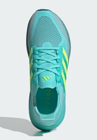 Turquoise running shoe with a breathable mesh upper, bright yellow accents, flat laces, and a cushioned sole for comfort.
