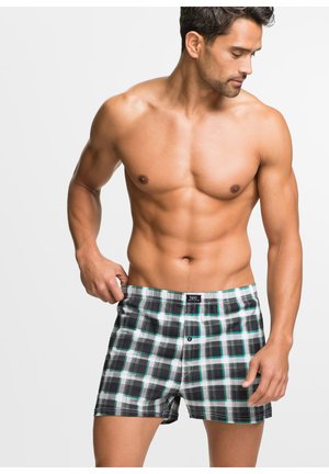 Boxer shorts à motifs en damier noir et blanc avec des accents turquoise, dotés d'une fermeture à bouton et d'une taille élastique. Texture de tissu douce.