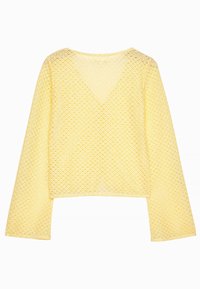 Gul cropped top med V-hals, lavet af et tekstureret, åbent strikket materiale. Har lange ærmer og en struktureret pasform.