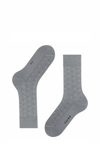 Graue Socken aus weicher Baumwolle, mit einem gepunkteten Muster aus schwarzen Punkten auf einer glatten Oberfläche. Inklusive einem gerippten Bündchen und einem Markenlogo.