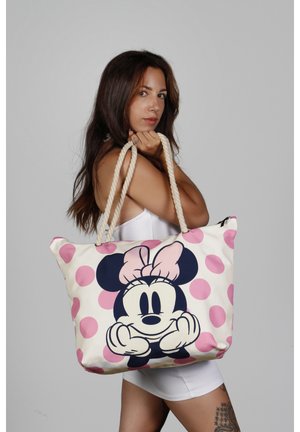 Bolsa de tela con un gran gráfico de Minnie Mouse con un lazo rosa, fondo crema y lunares rosas. Diseñada con asas de cuerda.