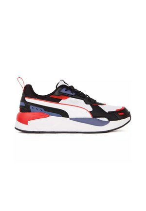Low-top athletic sneaker in white, black, red, and blue with lace-up front and thick cushioned sole, shown from the side.