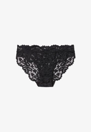 Schwarze Spitzenunterwäsche mit floralen Mustern, gewellten Kanten und einem transparenten Design, das mit einem blickdichten schwarzen Futter für Abdeckung versehen ist.