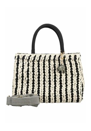 Sac à main tissé noir et blanc à rayures verticales, anses noires, breloque éléphant et bandoulière amovible à motif noir et blanc.
