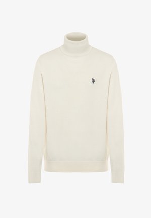 Maglione a collo alto in tessuto knit morbido. Presenta un design aderente, colletto e orli a coste, con un piccolo emblema scuro sul petto.