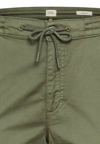 Heren shorts van olijfgroen stof met een trekkoord in de taille, voorzien van een voorzak en contrasterende stikseldetails.