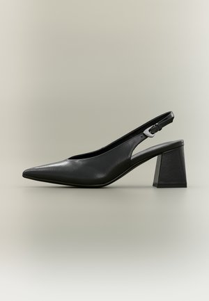 Black leather slingback shoe with pointed toe, silver buckle, and chunky block heel on a neutral background.