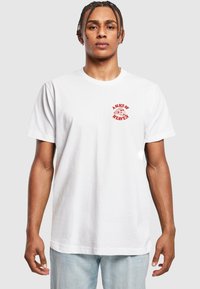 White cotton T-shirt featuring red graphic text "A Slice of Heaven" and pizza illustration on the left chest. Classic fit with short sleeves.