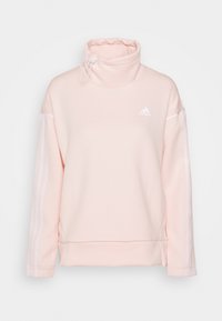 Sweat-shirt rose clair avec un col haut, texture côtelée, accents à rayures blanches le long des manches, et un logo adidas sur la poitrine.