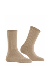 Beige geribbelde sokken van zacht materiaal, met een hoogte tot halverwege het kuit, elastische boorden en versterkte teen en hiel voor duurzaamheid.