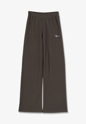 Brązowe spodnie o szerokich nogawkach z prążkowaną fakturą i elastycznym pasem. Na lewym biodrze znajduje się biała haftowana nazwa marki.