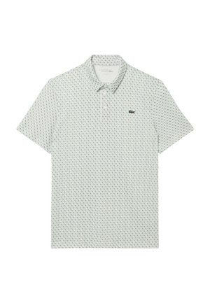Polo de manga corta blanco con patrón geométrico repetitivo en verde claro y pequeño logo de cocodrilo verde en el pecho izquierdo.
