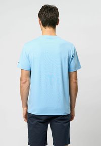 Light blue short-sleeve t-shirt made of smooth fabric, featuring a round neck and a relaxed fit. No visible patterns or accents.